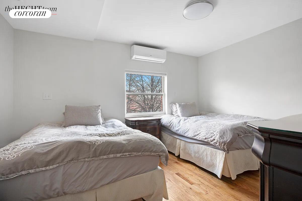 52 East 55th Street, Unit 2FAM Brooklyn, NY 11203 - Photo 5 of 12 a bedroom with a bed and two window