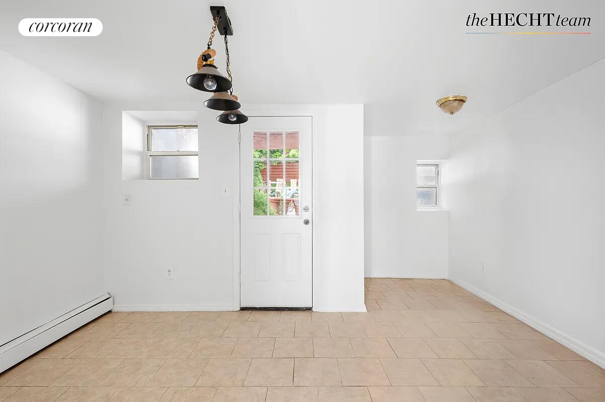 52 East 55th Street, Unit 2FAM Brooklyn, NY 11203 - Photo 9 of 12 an empty room with windows and ceiling fan