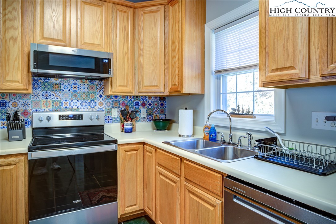 259 Ridge View Drive, Unit A Boone, NC 28607 - Photo 15 of 29 a kitchen with stainless steel appliances a stove a sink and cabinets