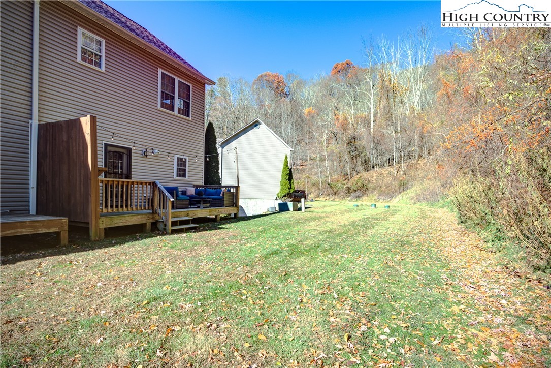 259 Ridge View Drive, Unit A Boone, NC 28607 - Photo 10 of 29 a backyard of a house with table and chairs