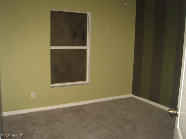 3805 22nd Street Southwest Lehigh Acres, FL 33976 - Photo 8 of 11 an empty room with a door