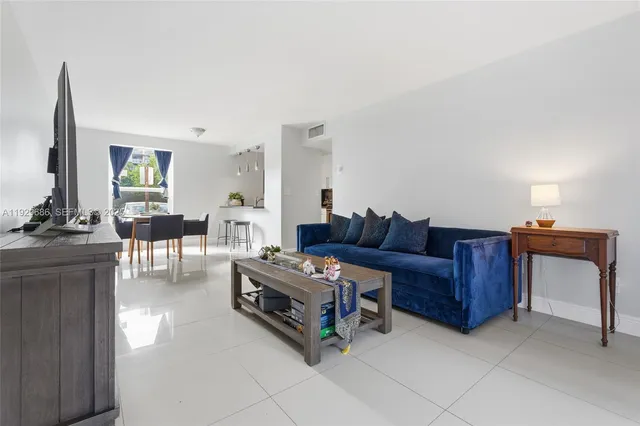 a living room with furniture and a dining table