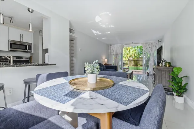 a kitchen with granite countertop a sink stove and refrigerator