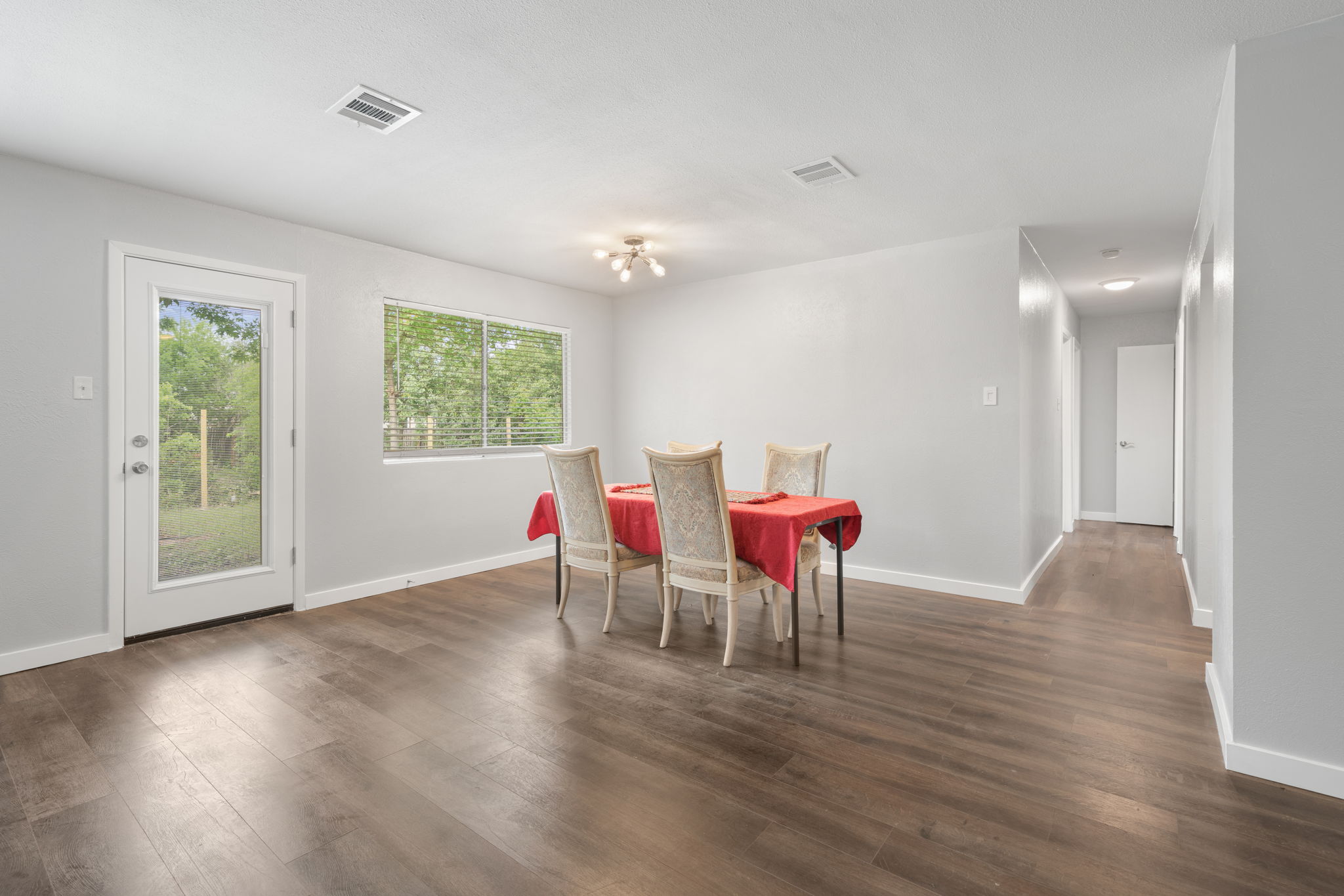 3917 Leafield Drive Austin, TX 78749 - Photo 12 of 40 Dining area featuring dark wood-style floors and hanging lights