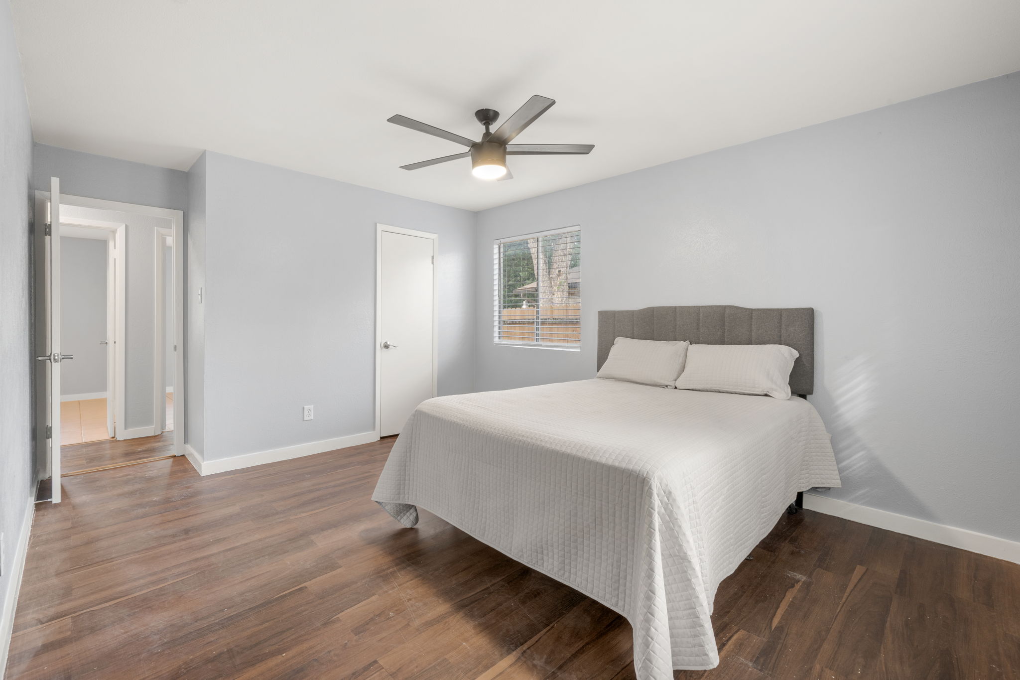 3917 Leafield Drive Austin, TX 78749 - Photo 13 of 40 Bedroom with dark wood-type flooring and a ceiling fan with walk in closet and ensuite bathroom