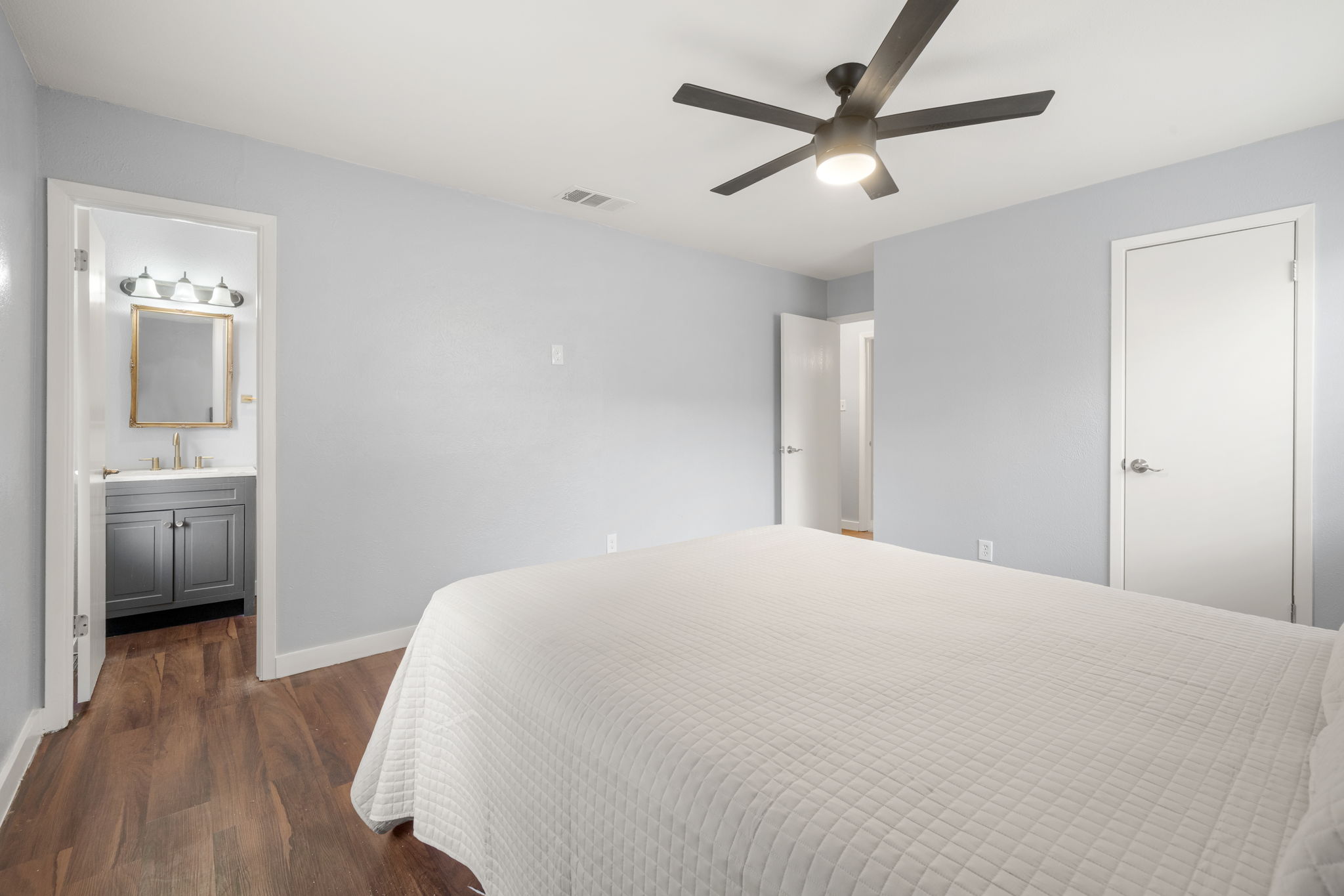 3917 Leafield Drive Austin, TX 78749 - Photo 14 of 40 Bedroom featuring dark wood-style flooring, a ceiling fan, and ensuite bathroom