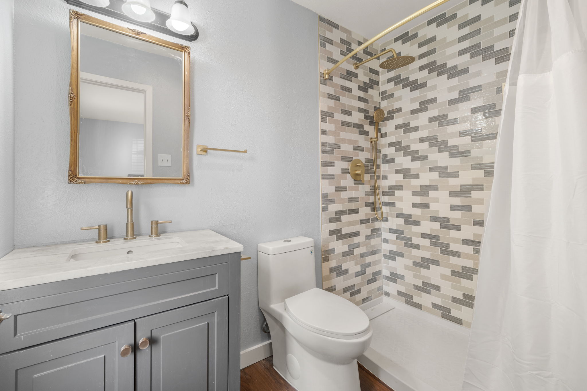 3917 Leafield Drive Austin, TX 78749 - Photo 15 of 40 Bathroom with vanity, a stall shower, and dark wood-style floors