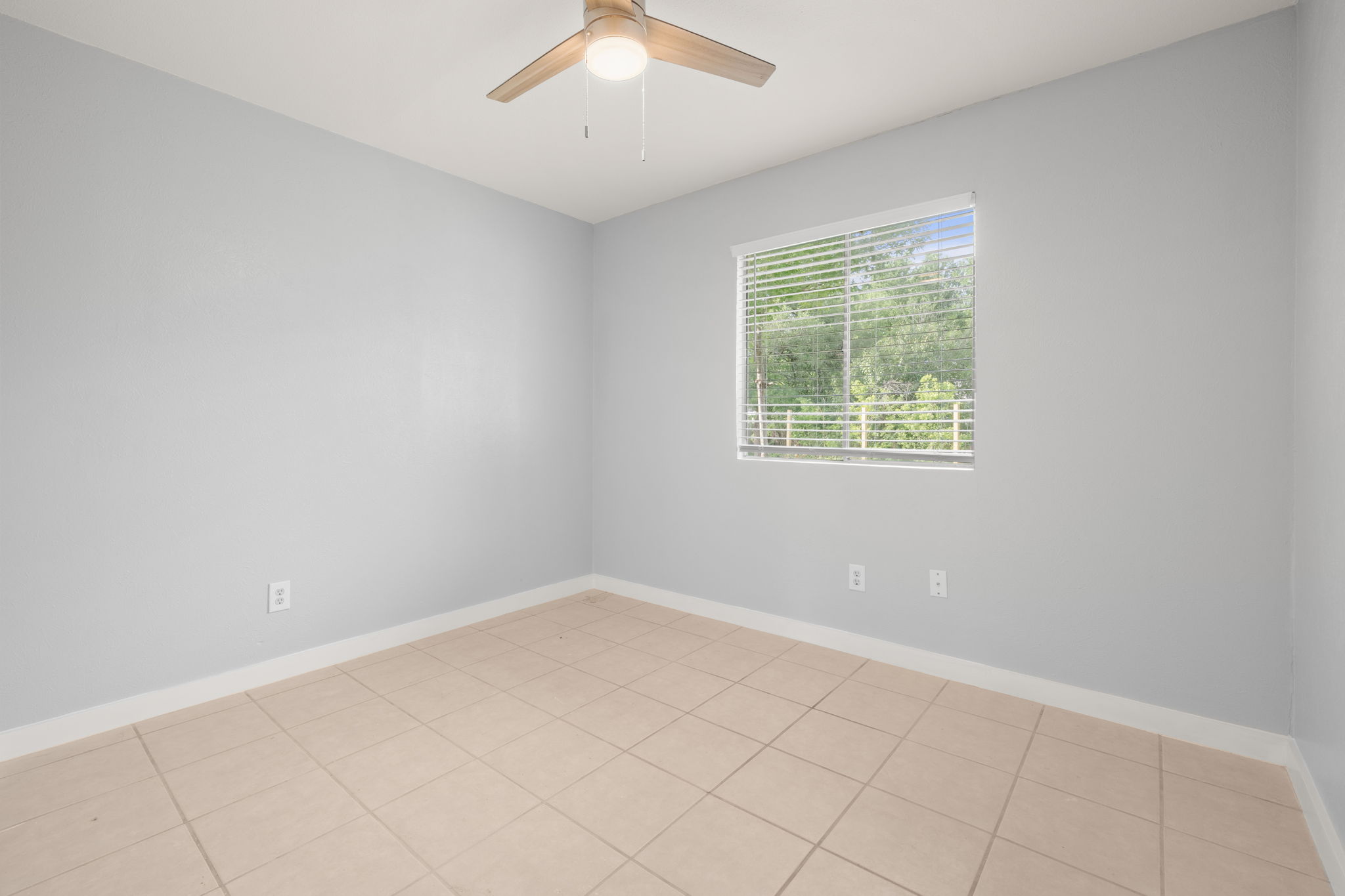 3917 Leafield Drive Austin, TX 78749 - Photo 17 of 40 Bedroom # 2 with ceiling fan and light tile-patterned floors