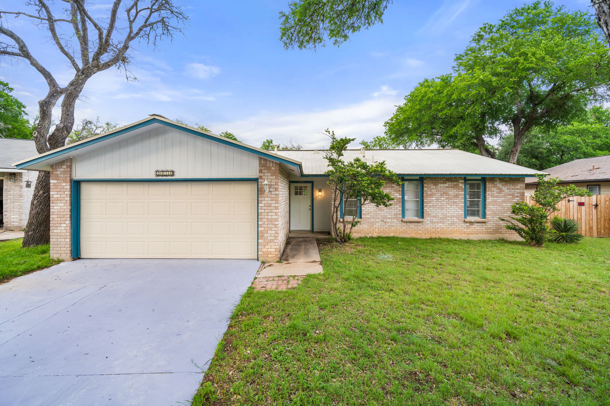 3917 Leafield Drive Austin, TX 78749 - Photo 2 of 40 Ranch-style house featuring concrete driveway, an attached garage, and brick siding