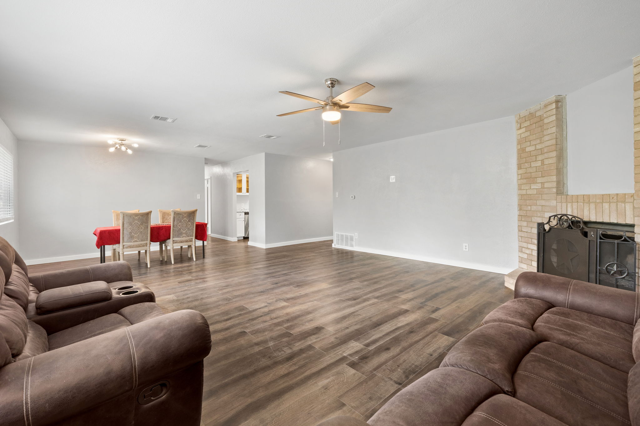 3917 Leafield Drive Austin, TX 78749 - Photo 26 of 40 Living area featuring a brick fireplace, dark wood finished floors, and ceiling fan