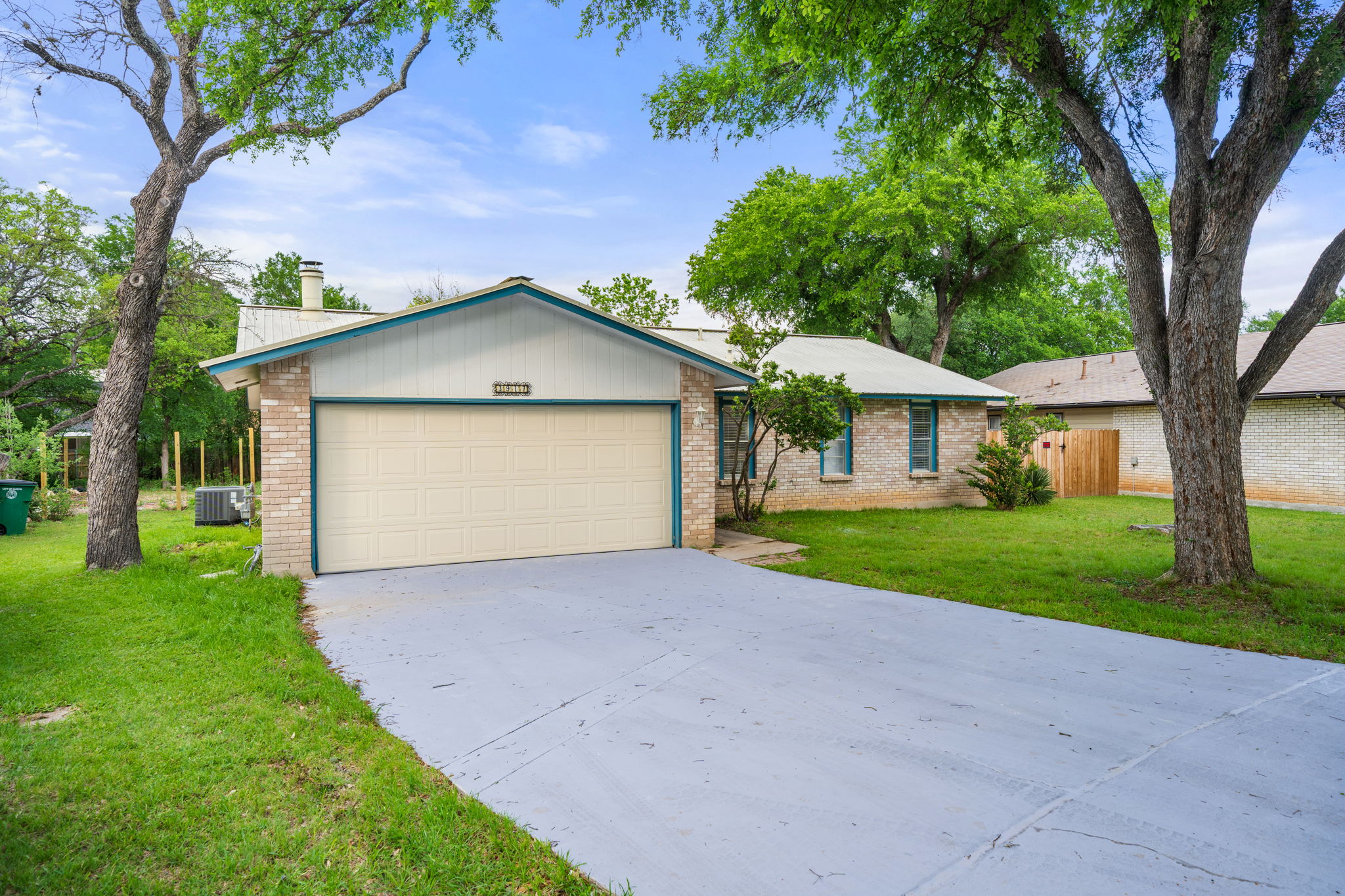 3917 Leafield Drive Austin, TX 78749 - Photo 3 of 40 Ranch-style home with a front yard, driveway, an attached garage, and brick siding