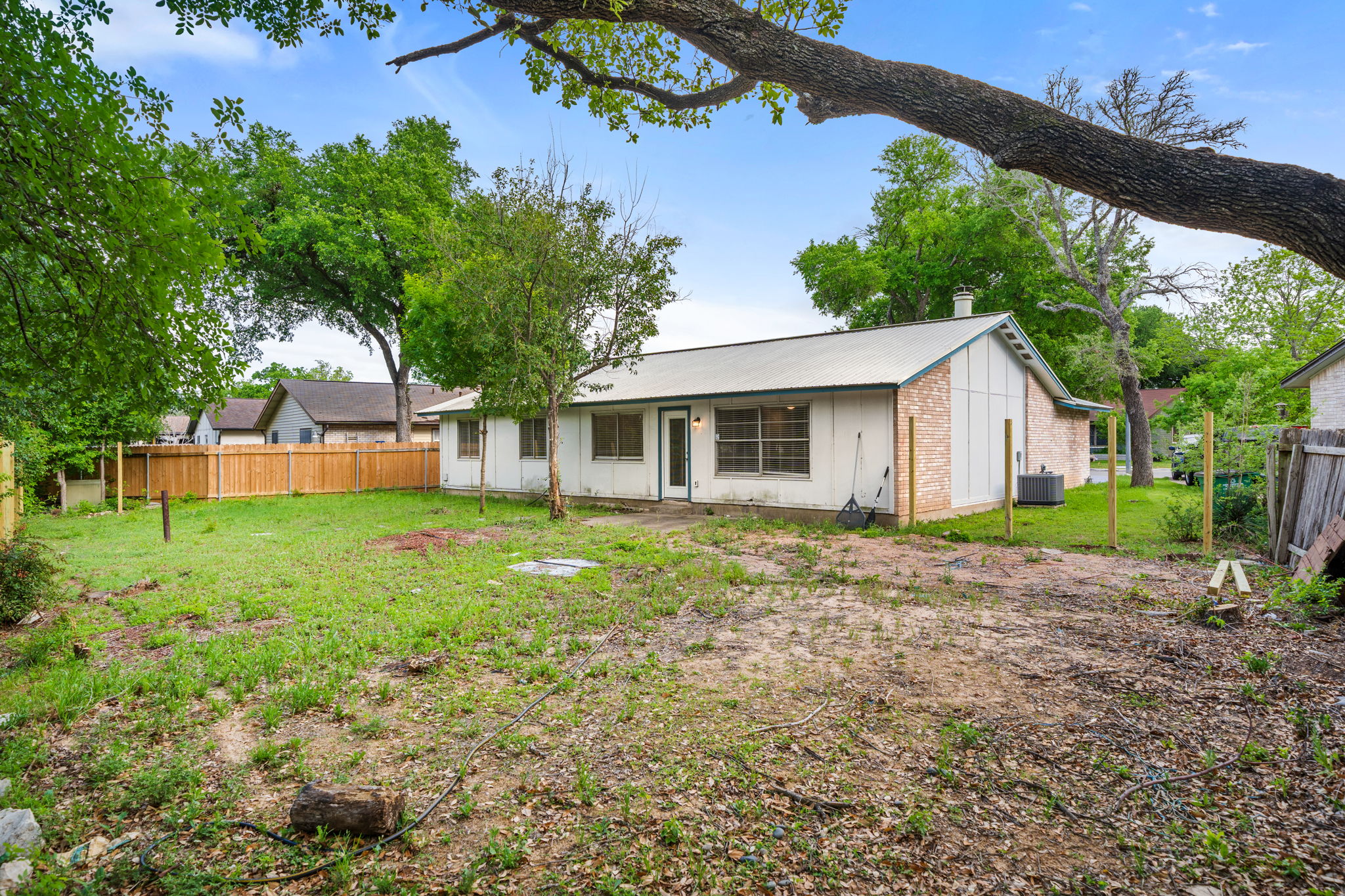 3917 Leafield Drive Austin, TX 78749 - Photo 33 of 40 Rear view of property featuring brick siding and a chimney