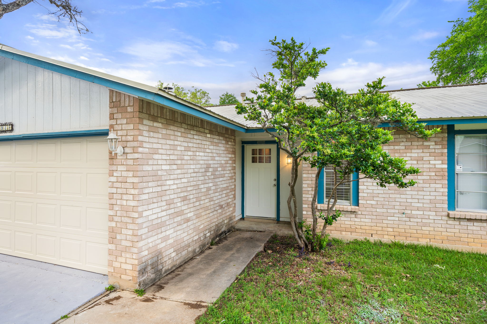 3917 Leafield Drive Austin, TX 78749 - Photo 38 of 40 Property entrance featuring brick siding and an attached garage