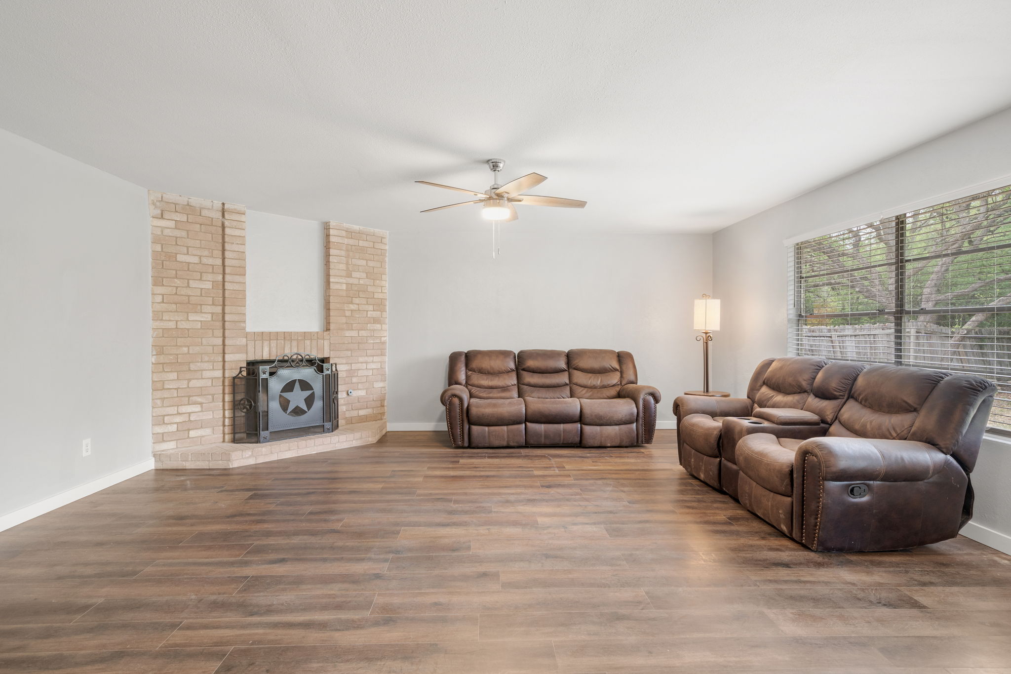 3917 Leafield Drive Austin, TX 78749 - Photo 8 of 40 Living room with wood finished floors, a ceiling fan, and a wood burning fireplace