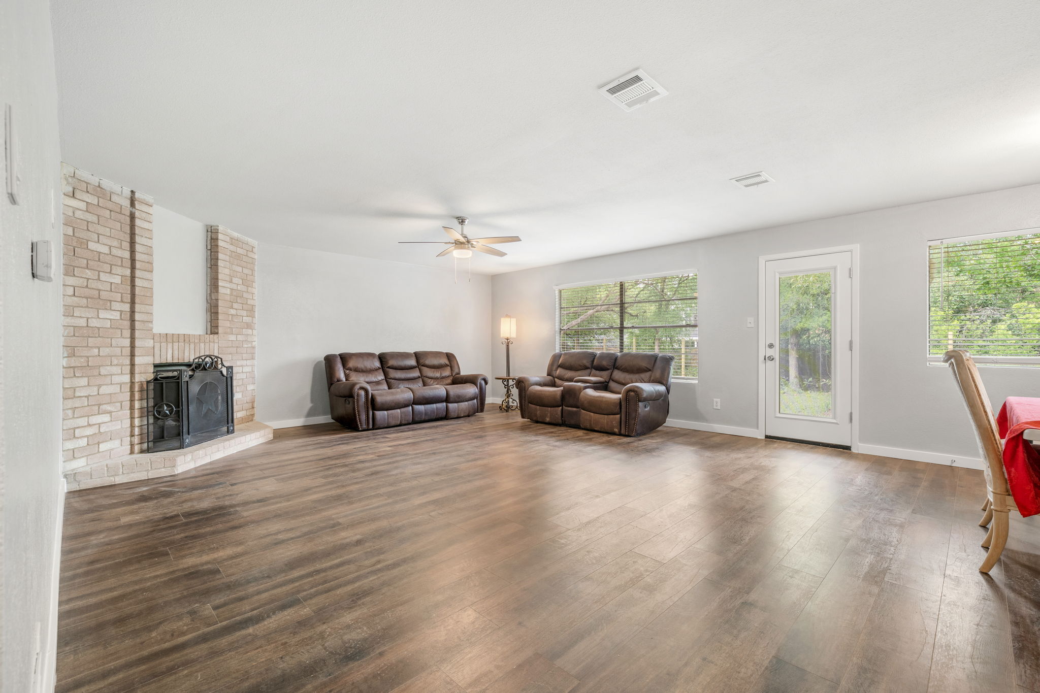 3917 Leafield Drive Austin, TX 78749 - Photo 9 of 40 Natural light floods the living room featuring dark wood finished floors and a ceiling fan