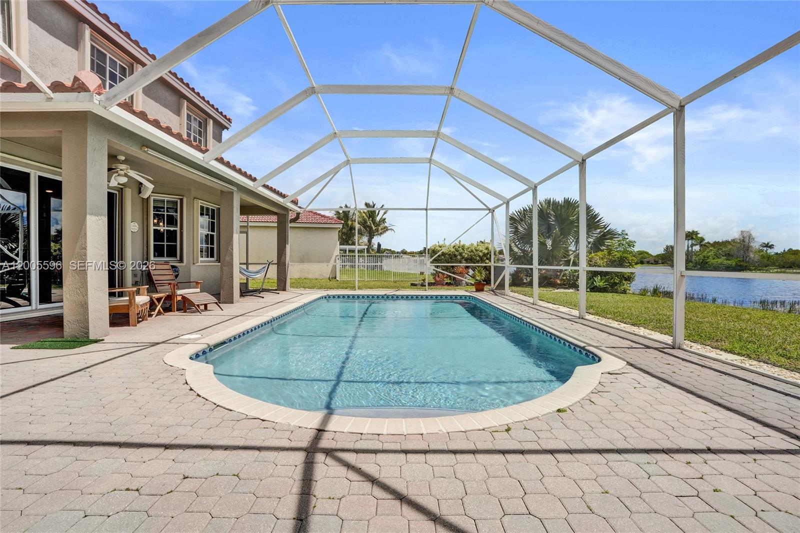 4281 Laurel Ridge Circle Weston, FL 33331 - Photo 38 of 80 a view of a swimming pool with a lounge chairs