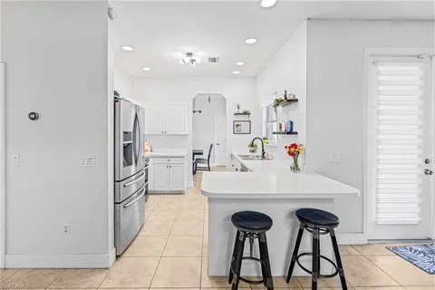 a view of kitchen with refrigerator and window