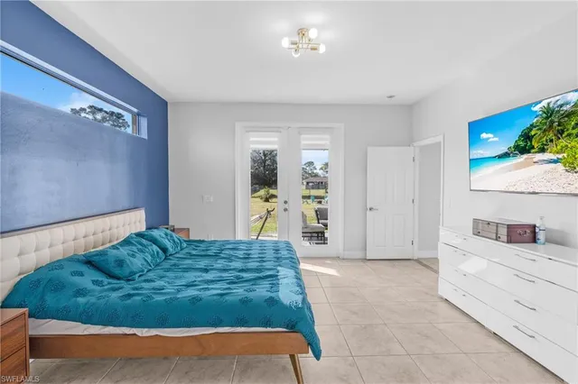 a spacious bedroom with a bed and a couch