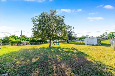 a front view of a house with yard and swimming pool