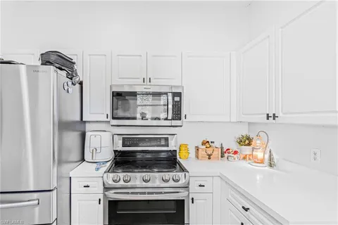 a kitchen with a stove and a refrigerator