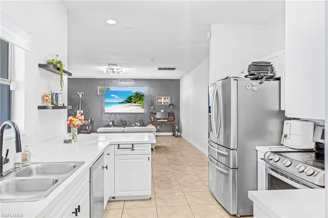 a kitchen with stainless steel appliances a sink stove and refrigerator