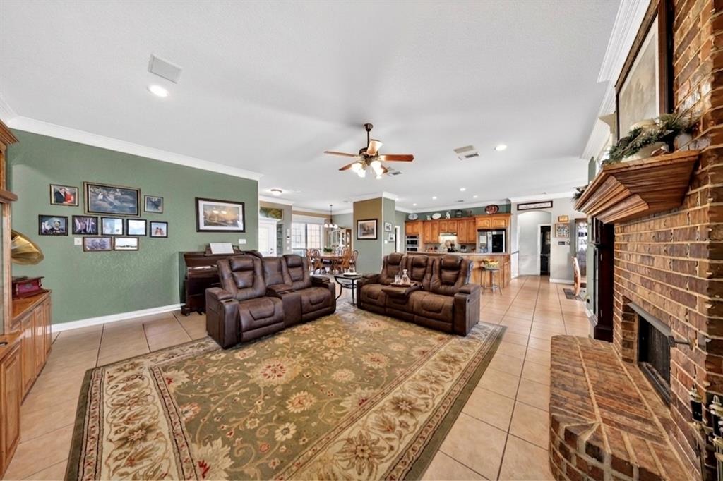 1035 Highland Road Cleburne, TX 76033 - Photo 15 of 36 a living room with furniture and a fireplace