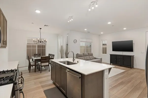 a kitchen with a sink a counter top space and stainless steel appliances