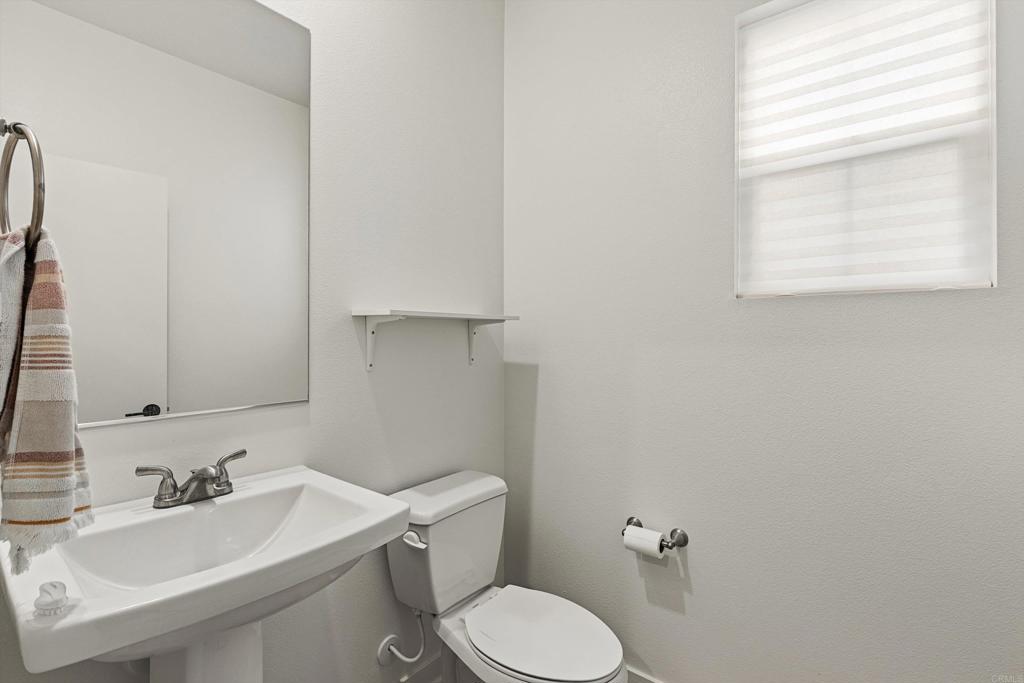 227 Canopy Trails Place Fallbrook, CA 92028 - Photo 18 of 66 a bathroom with a toilet sink and mirror