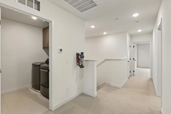 an empty room with windows and ceiling fan