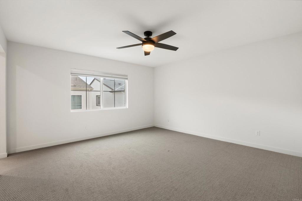 227 Canopy Trails Place Fallbrook, CA 92028 - Photo 21 of 66 an empty room with windows and ceiling fan