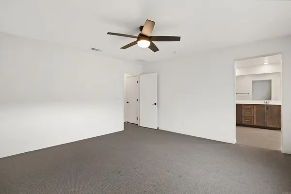 a spacious bathroom with a double vanity sink mirror and toilet