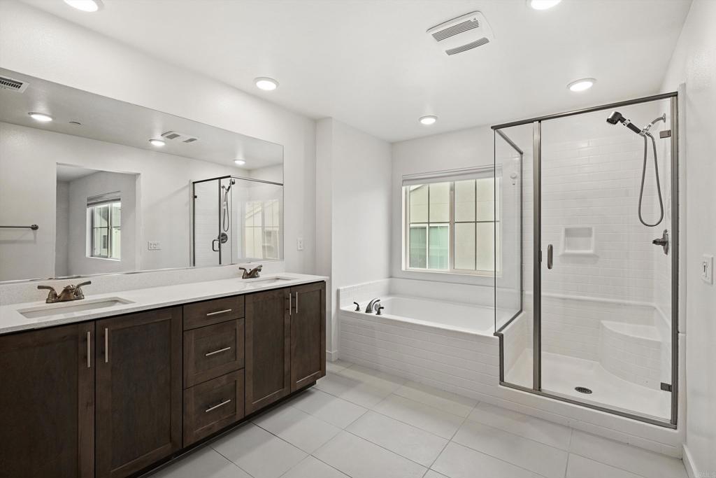 227 Canopy Trails Place Fallbrook, CA 92028 - Photo 24 of 66 a spacious bathroom with a shower sink vanity and mirror