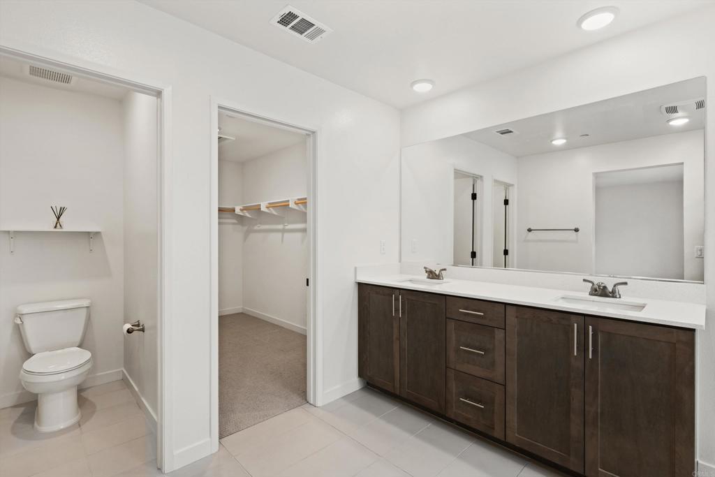 227 Canopy Trails Place Fallbrook, CA 92028 - Photo 25 of 66 a spacious bathroom with a double vanity sink mirror and toilet