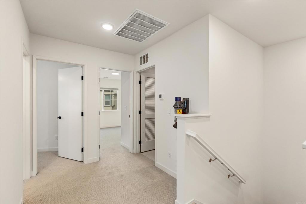 227 Canopy Trails Place Fallbrook, CA 92028 - Photo 27 of 66 a view of a hallway with closet and wooden floor