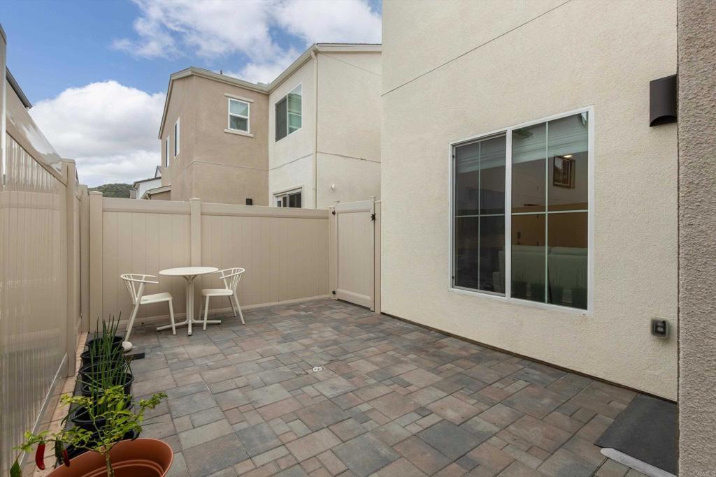 227 Canopy Trails Place Fallbrook, CA 92028 - Photo 34 of 66 a view of a patio with table and chairs and potted plants