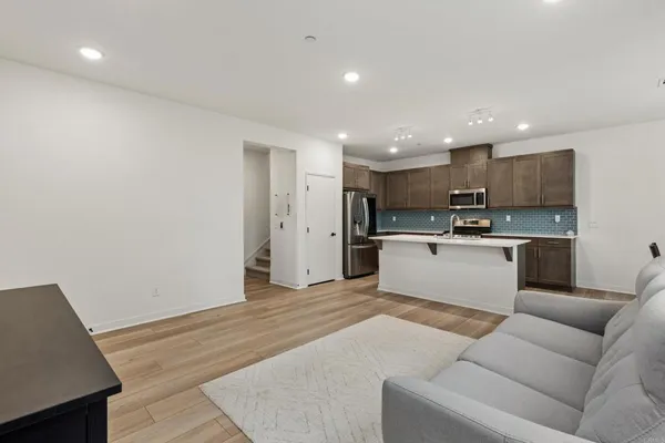 a view of kitchen with kitchen island a sink a stove and a refrigerator