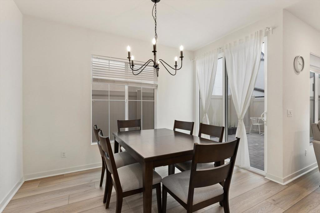 227 Canopy Trails Place Fallbrook, CA 92028 - Photo 9 of 66 a view of a dining room with furniture window and wooden floor