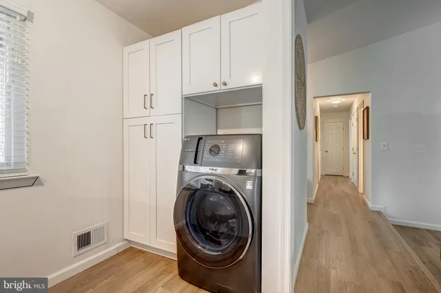 a view of a storage and utility room with washer and dryer