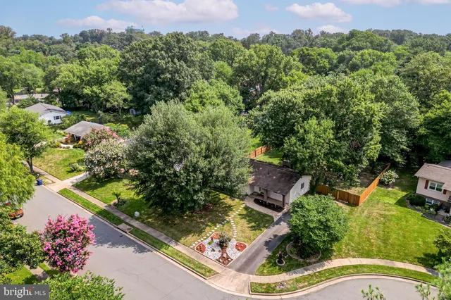 an aerial view of a house with a yard and garden