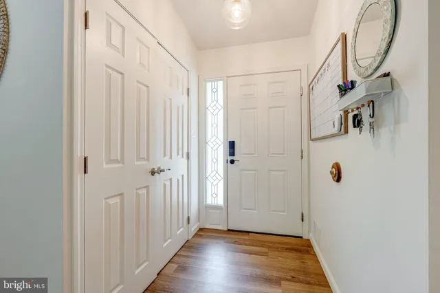 a view of a hallway with wooden floor and entryway