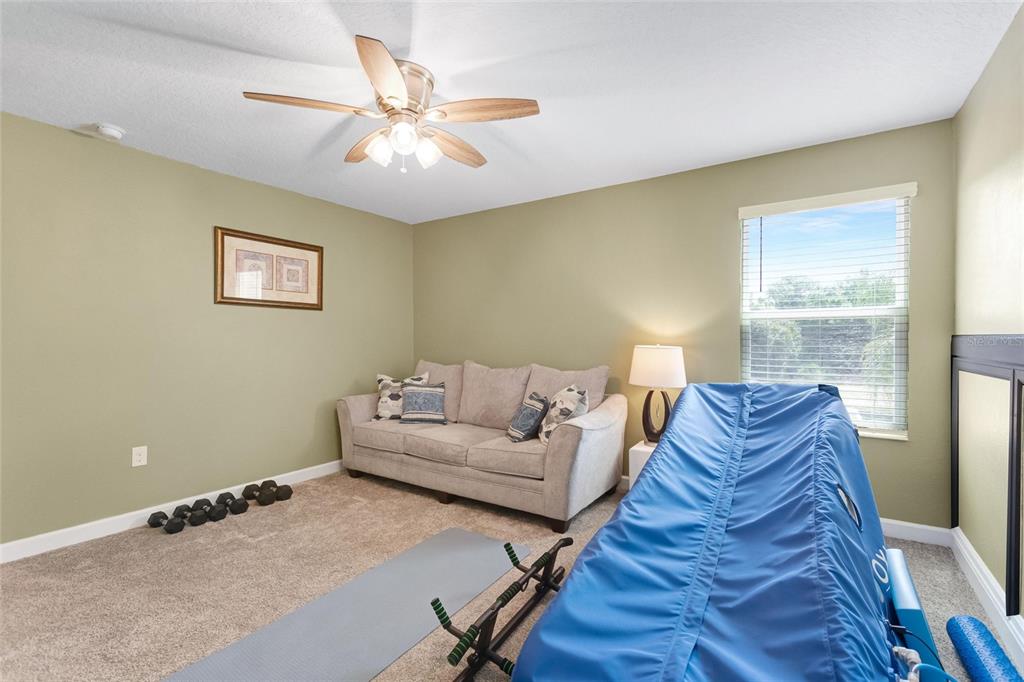 1089 Blackwolf Run Road Davenport, FL 33896 - Photo 36 of 82 a living room with furniture and a window