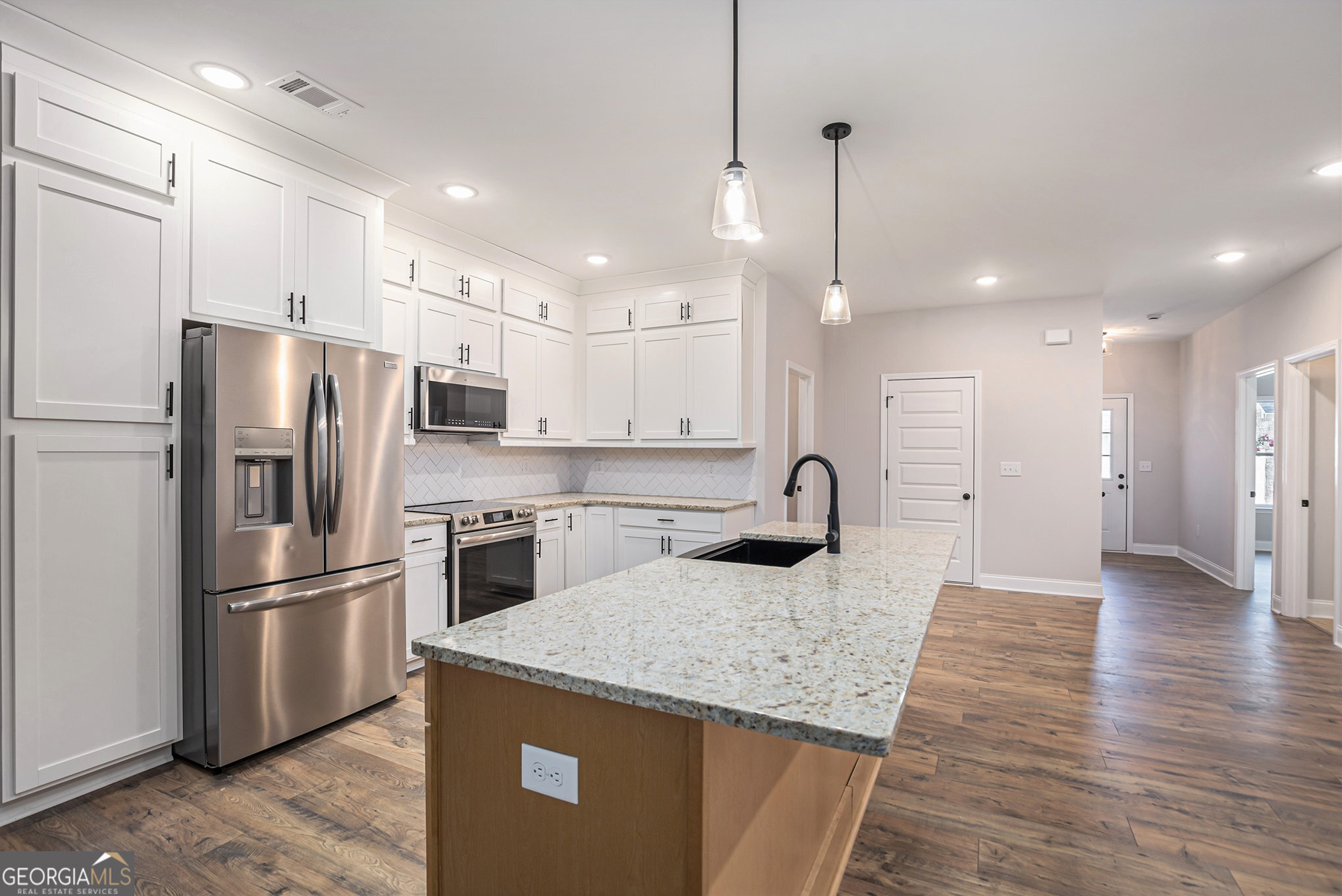 138 Crest Pointe Bremen, GA 30110 - Photo 11 of 22 a kitchen with stainless steel appliances granite countertop a refrigerator a sink dishwasher a stove and a refrigerator with wooden floor