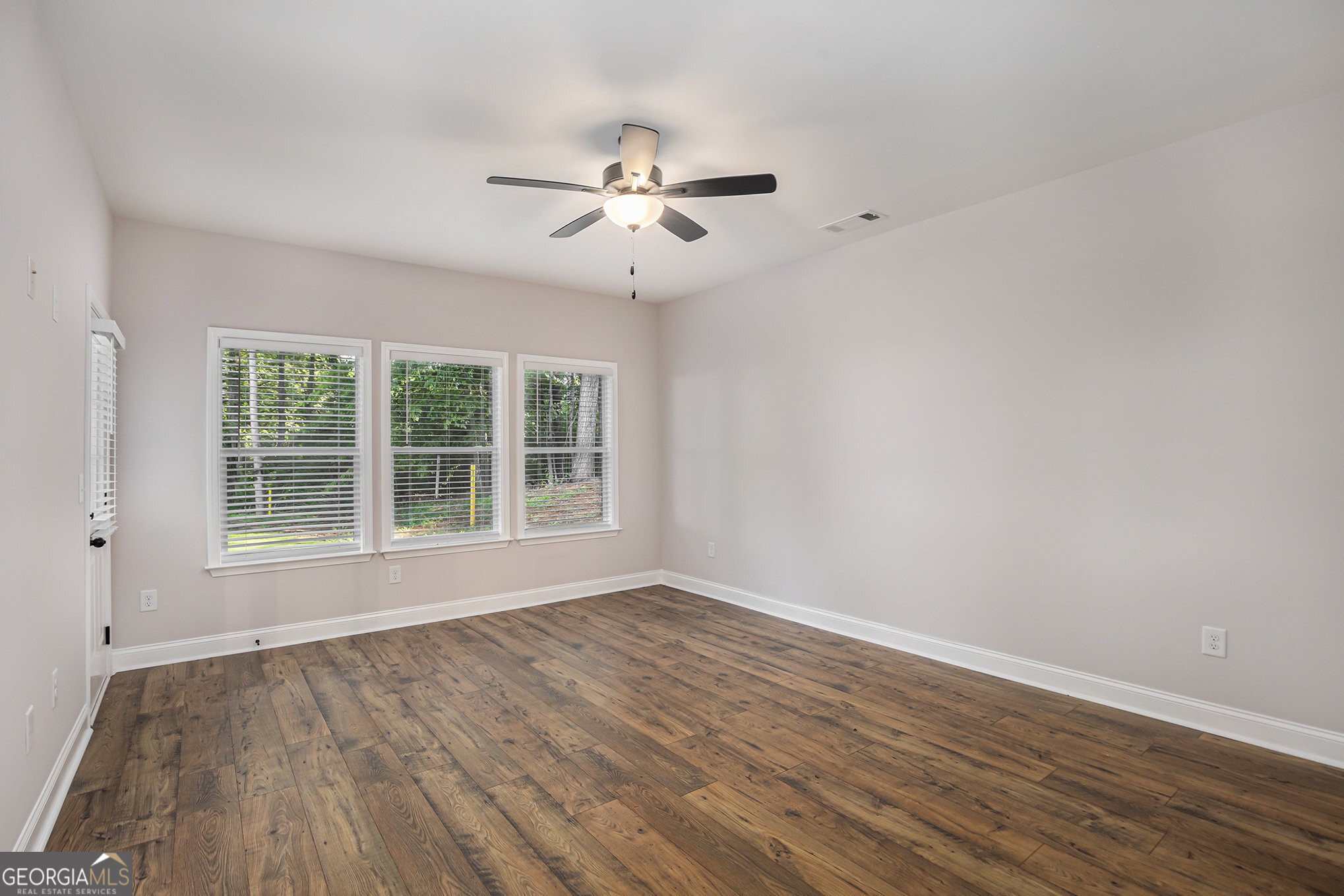 138 Crest Pointe Bremen, GA 30110 - Photo 12 of 22 a view of an empty room with wooden floor and a window