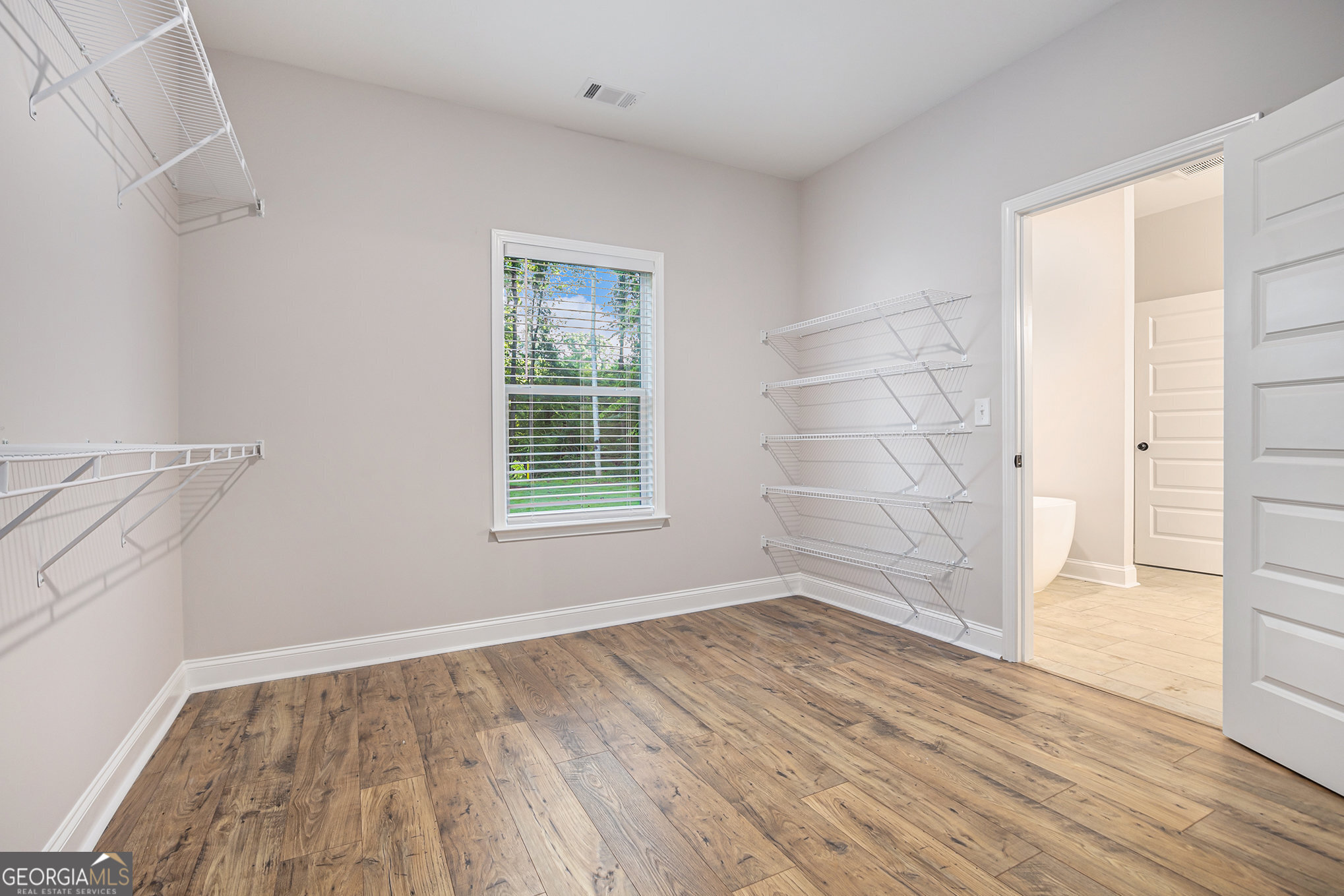 138 Crest Pointe Bremen, GA 30110 - Photo 16 of 22 an empty room with wooden floor and windows