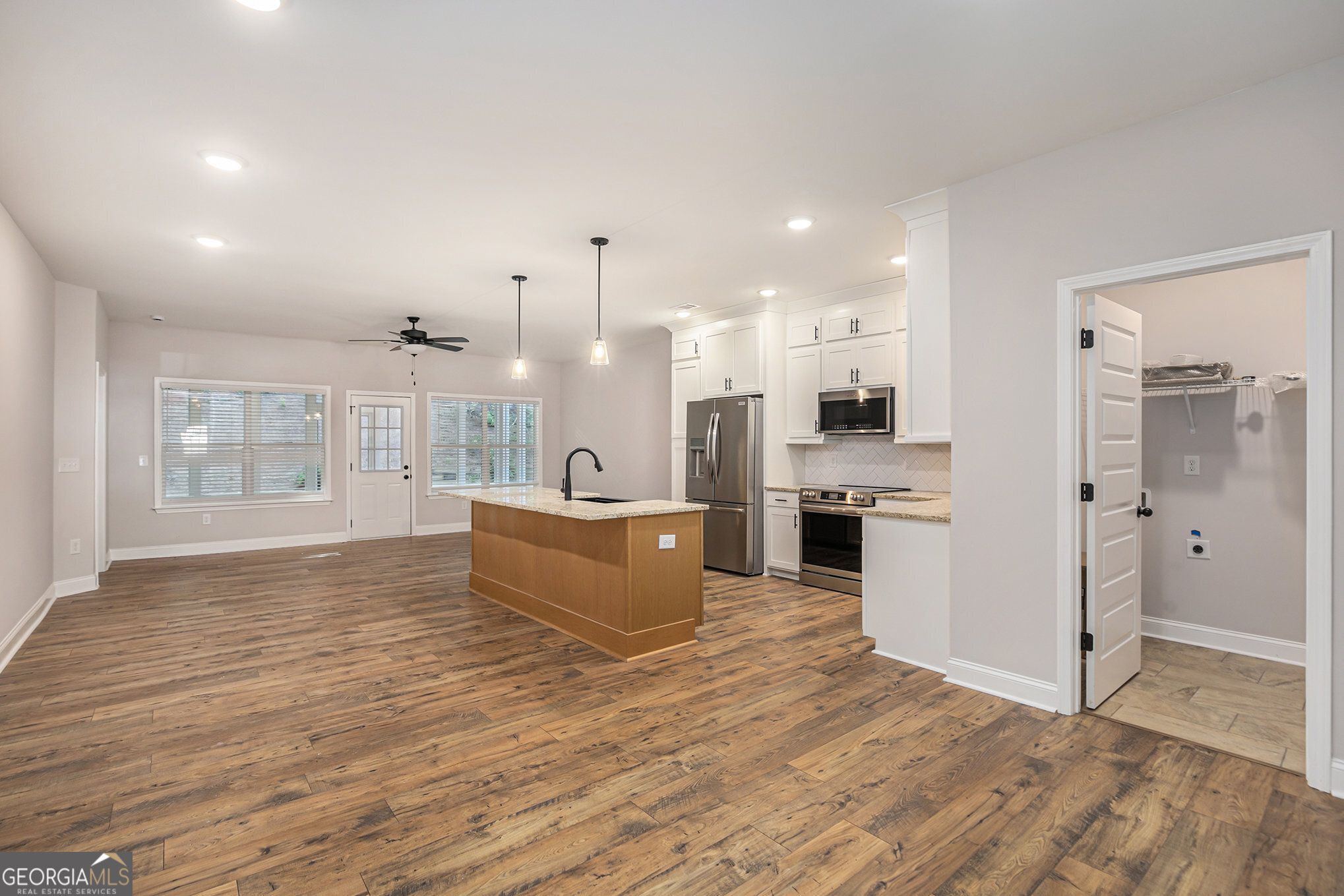 138 Crest Pointe Bremen, GA 30110 - Photo 3 of 22 a large kitchen with stainless steel appliances kitchen island a large counter top and a wooden floors