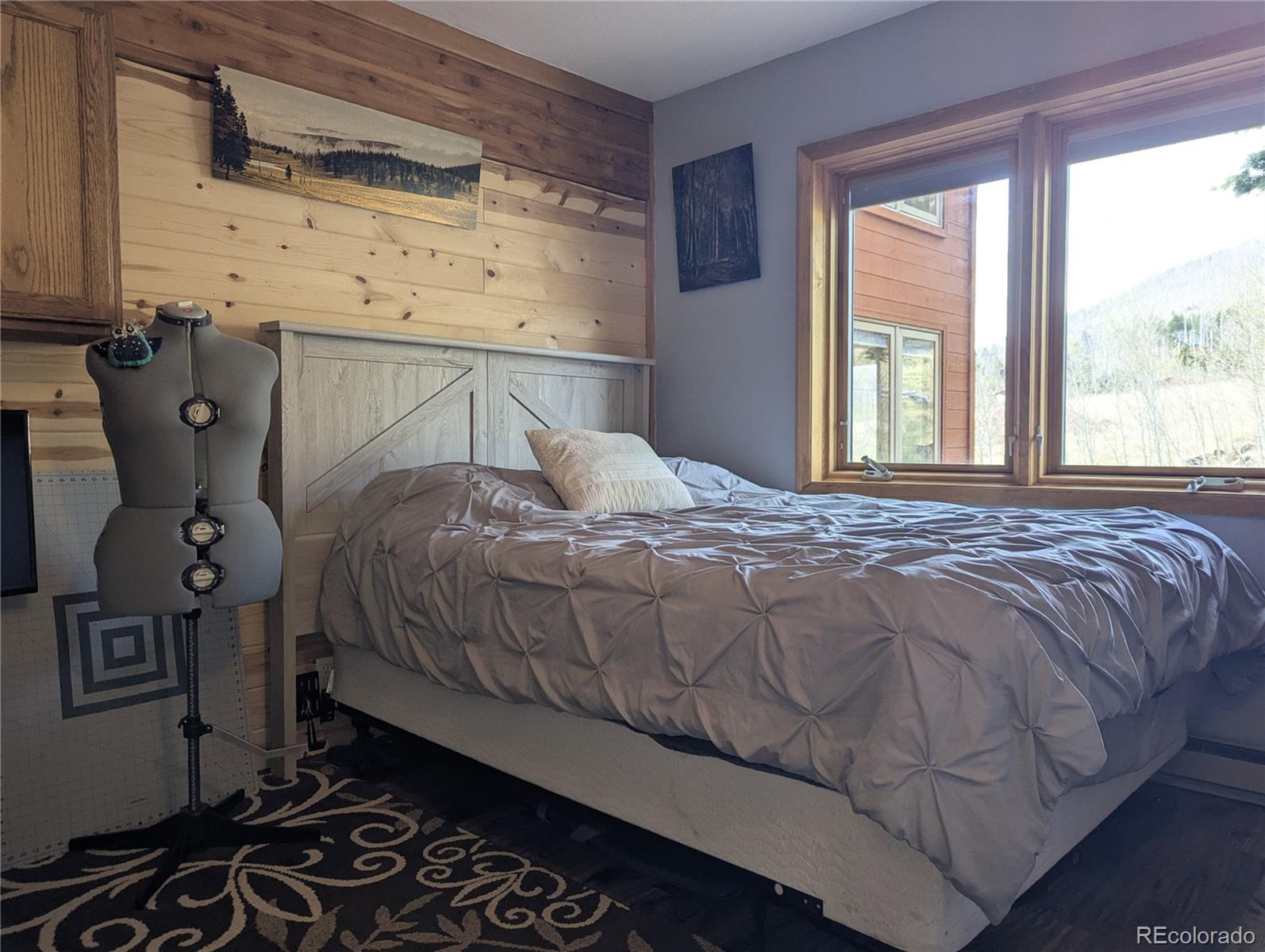 2084 Forbes Park Road Fort Garland, CO 81133 - Photo 26 of 39 a bedroom with a bed and wooden floor