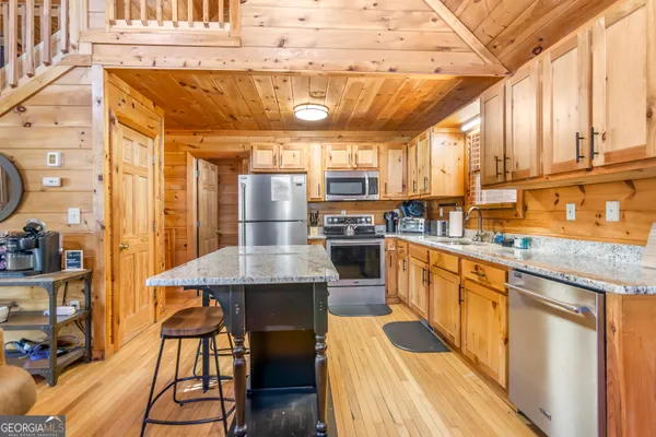 a kitchen with stainless steel appliances granite countertop a sink and cabinets