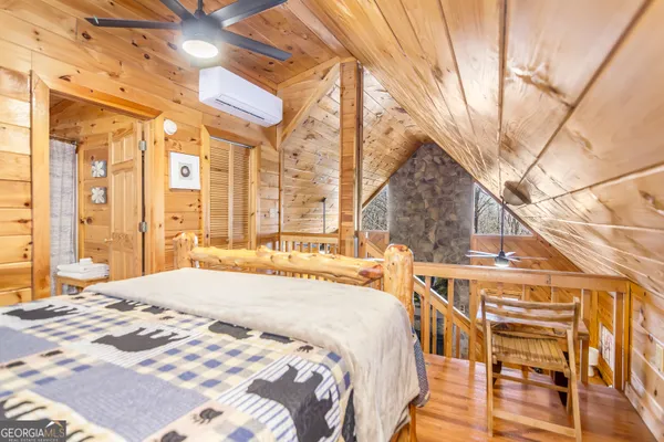 a spacious bedroom with a bed and a window