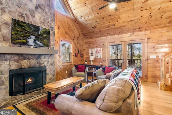 a living room with furniture a fireplace and a flat screen tv