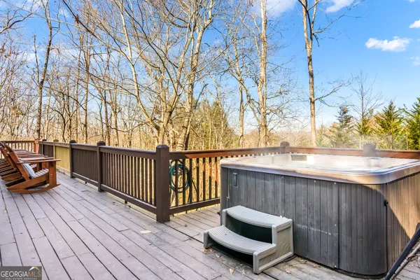 a view of balcony with wooden floor and seating space